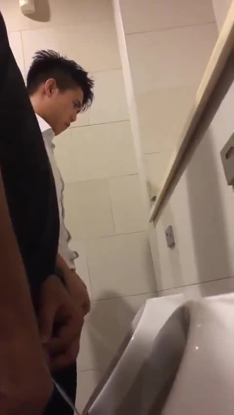 A male is pissing in the toilet 24.