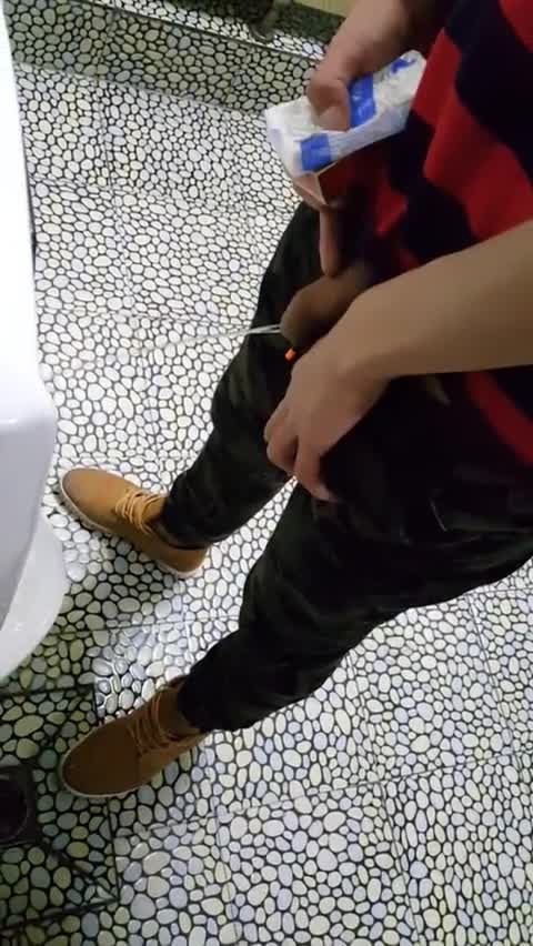 A male is pissing in the toilet 31.