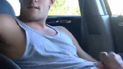 Big-cock jock strokes in his car